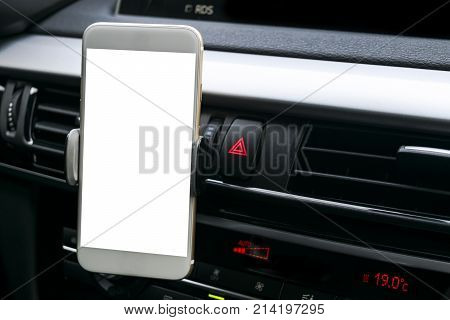 Smartphone in a car use for Navigate or GPS. Driving a car with Smartphone in holder. Mobile phone with isolatede white screen. Blank empty screen. copy space. Empty space for text. car interior