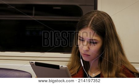 Young Businesswoman Traveling Train Tablet Computer. Young Woman In Subway Works In The Tablet.