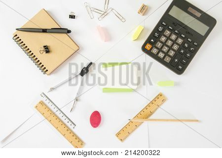 Close up of white office table with various supplies and items. Workplace office education accounting concept
