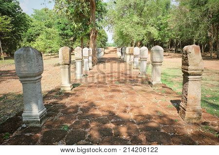 Wide Path of Red Laterite Brick Pavement or Walkway in A Public Historical Park for Walking Along with Shiva Lingam Pole.