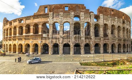 Rome, Italy - May 12, 2016: sunset with clouds and tourists visiting the Colosseum, Flavian Amphitheatre, the largest amphitheater in the world and one of the symbols of Italy and Rome.
