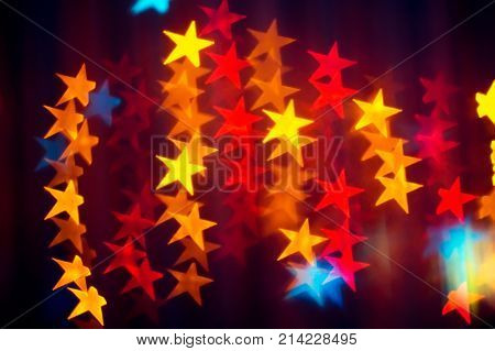Bright abstract background with multicolored garland stars