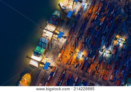 Containers yard in port congestion with ship vessels are loading and discharging operations of the transhipments in international port.