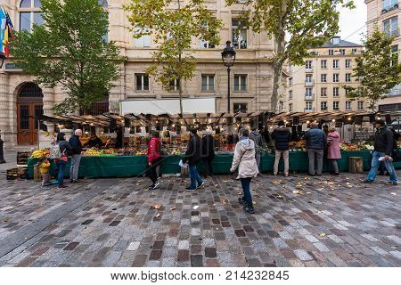 Paris France -- November 4 2017 -- Shoppers at a Parisan farmers market in Autumn. Editorial Use Only.