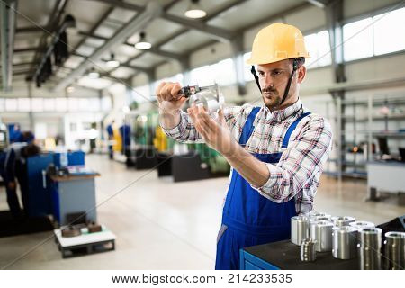 Supervisor doing quality control and pruduction check in metal factory