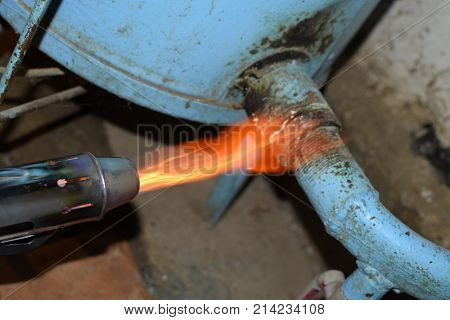 Heating A Steel Pipe With A Blowtorch. The Flame Of A Blowtorch