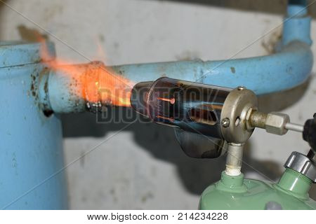 Heating A Steel Pipe With A Blowtorch. The Flame Of A Blowtorch