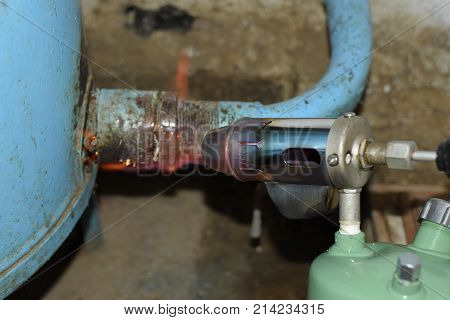 Heating A Steel Pipe With A Blowtorch. The Flame Of A Blowtorch