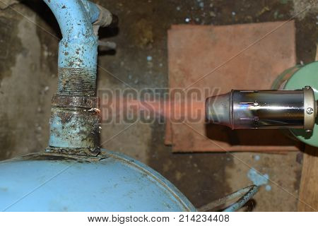 Heating A Steel Pipe With A Blowtorch. The Flame Of A Blowtorch