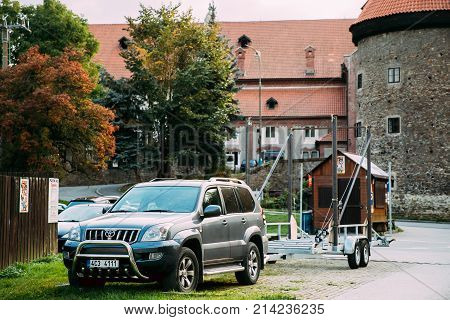 Cesky Krumlov, Czech Republic - September 25, 2017: Front View Toyota Land Cruiser Prado Serie 120 Car Of Grey Metallic With Trailer Parked In Street. Car Of Third Generation
