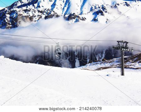 Cableway in the mountains of Dombai. Winter Sunny day.