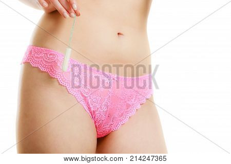 Women hygiene protection concept. Part body woman with tampon. Girl in lacy lingerie on time of menstruation monthly cycle.
