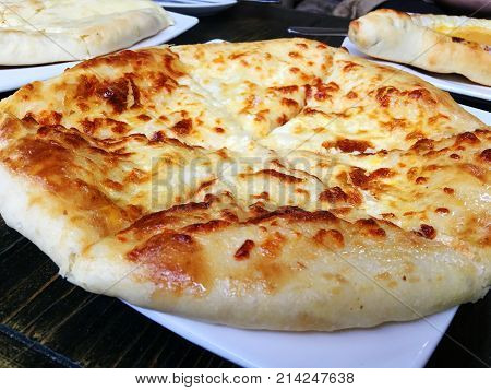 Traditional Georgian pie - khachapuri is a cake baked in the oven with cheese