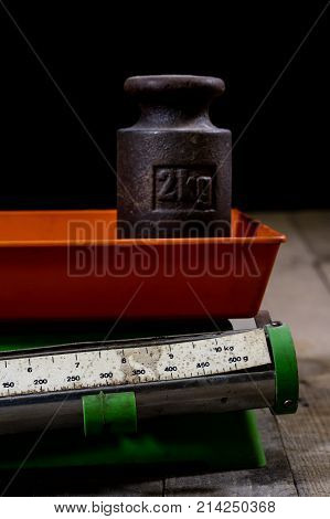 Old Weight And Weights On A Wooden Table. Old Used Kitchen Scale With Old Scale And Kilogram Weight