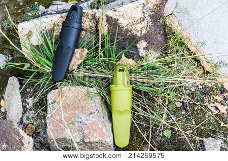 Two Swedish Knives In Plastic Sheath. Horizontal Frame.