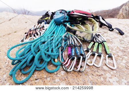 Climbing equipment - bag for magnesia rope and carbines view from the side close-up. A rocks and mountains on background. Concept of outdoor sport