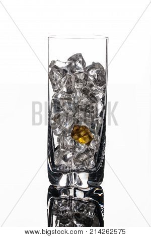 Crystals of ice in a glass with water on a glass background