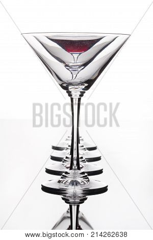 Glass with a red wine on a glass studio background