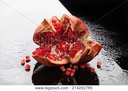 Pomegranate on a glass background with drops of water