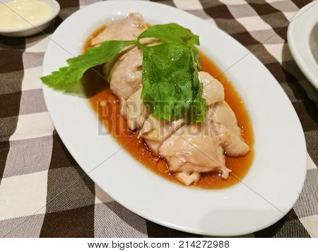 Juicy Singaporean Hainanese chicken rice on sesame oil sauce