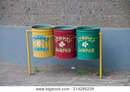 Three recycle bins in Bali. The word Tempat Sampah means Trash Can.