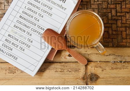 Kopi Luwak Bali famous organic Palm Civet coffee with wooden spoon and menu