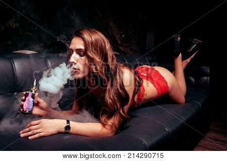 Sexy young woman in a red lingerie in studio