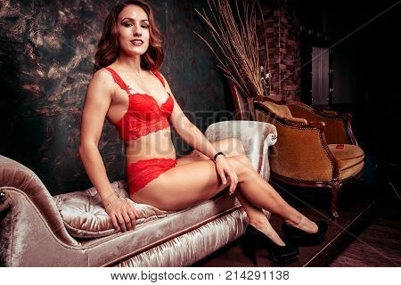 Sexy young woman in a red lingerie in studio