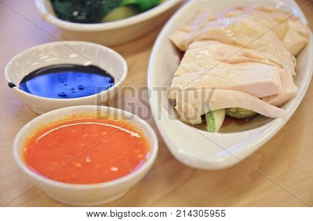 Delicious legendary Singaporean Hainanese chicken rice with two tones dipping sauce