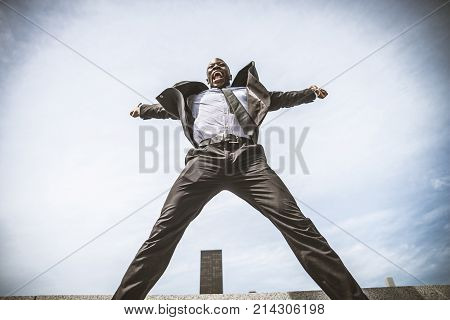 Confident happy businessman exulting outdoors in NY