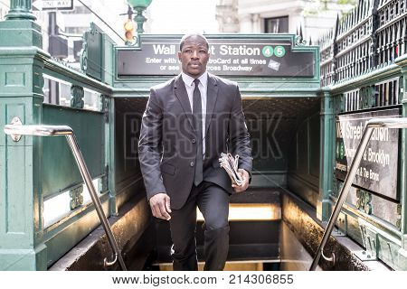 Businessman in full suit at Wall Street subway metro station