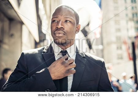 Corporate businessman portrait - Confident business man walking in wall street