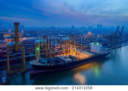 Containers yard in port congestion with ship vessels are loading and discharging operations of the transhipments in international port.