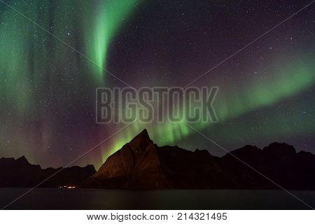 Northern lights over Olstind mountain Lofoten Norway