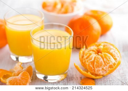 Tangerines peeled tangerines and tangerine juice in glass. Mandarine juice.