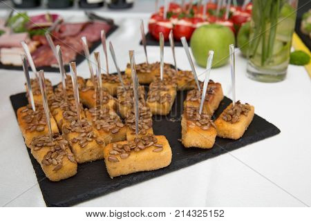cheese sticks on a black stone board. Snacks. buffet table. restaurant feed. New Year Christmas