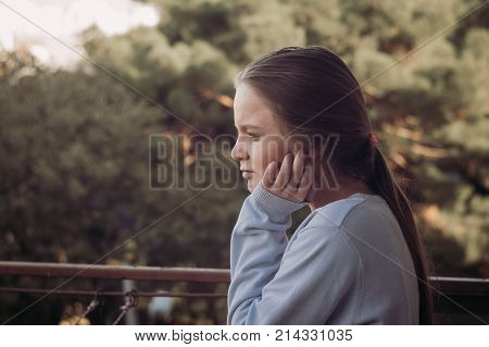 Girl thinking portrait on balcony. autumn time