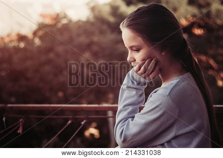 Girl thinking portrait on balcony. autumn time