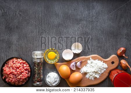 Composition of raw meat with vegetables and spice on wooden background. Top view. Copy space. Still life. Flat lay.