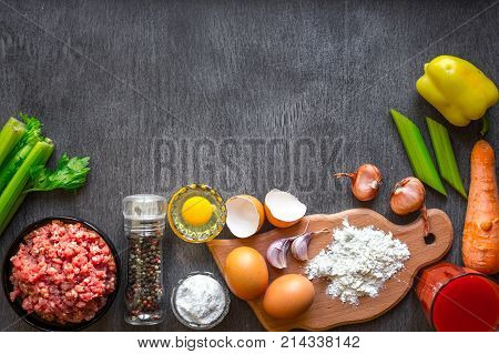 Composition of raw meat with vegetables and spice on wooden background. Top view. Copy space. Still life. Flat lay.