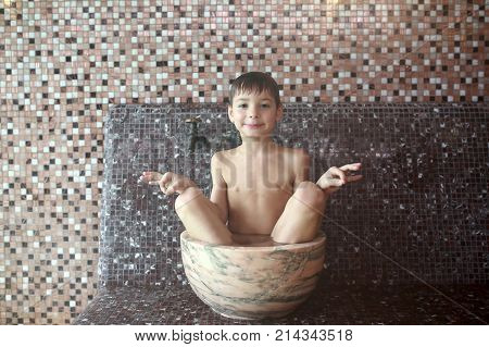 Boy Sitting In Hammam