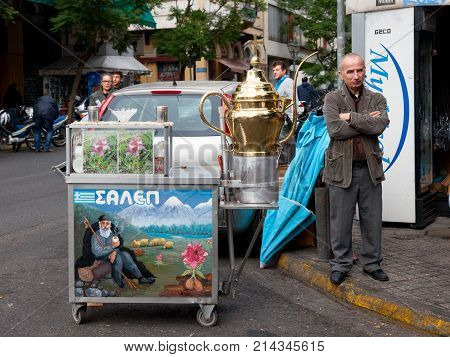 ATHENS GREECE - NOVEMBER 4 2017: Old man selling Salep from a cart. Salep is a typical drink from Greece and Turkey made of hibiscus flower