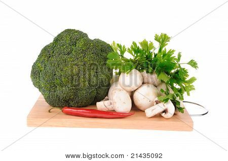 Cogumelos Brocolli pimenta sobre a placa de corte isolada no fundo branco