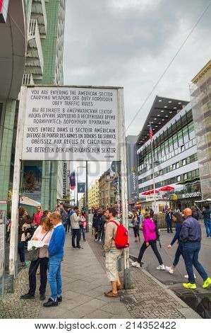 BERLIN - AUGUST 21 2017: Historical sign at Checkpoint Charlie on August 21 2017 in Berlin Germany. The name was given by the Western Allies to the best-known Berlin Wall crossing point between East and West Berlin.