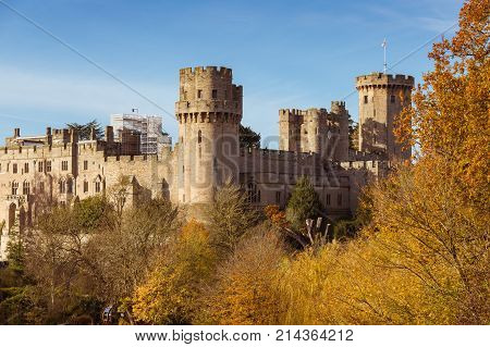 Warwick castle on the river Avon warm autumn day fall colours, Warwick, Warwickshire, England, UK, November 2017
