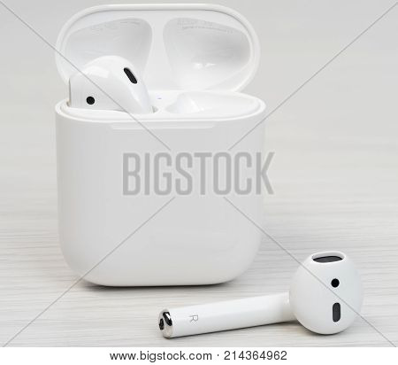 UFA RUSSIA - OCTOBER 20 2017: AirPods wireless bluetooth headphones developed by Apple Inc. Apple Airpods in open box.