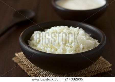 Kefir grains in rustic bowl photographed with natural light (Selective Focus Focus one third into the kefir grains)