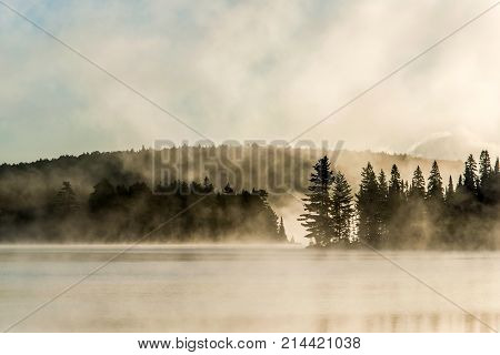 Lake of two rivers in algonquin national park ontario canada sunset sunrise with fog foggy mystical atmosphere background