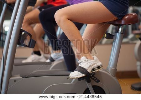 Detail of a group of people biking in a gym