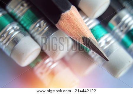one sharpened pencil laying on pencil erase.